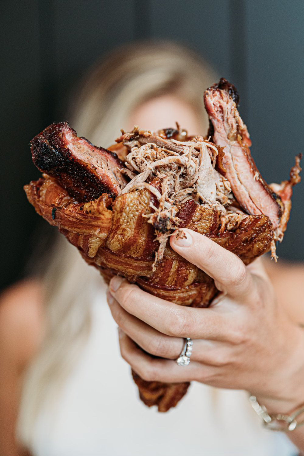Apple Chipotle Smoked Pulled Pork bacon Cup stacked high with pulled pork, bbq sauce and pork ribs.