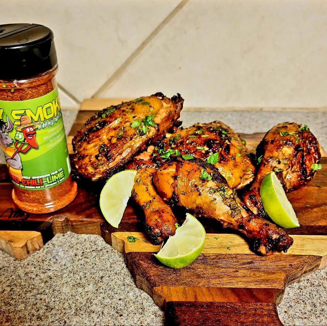 Smoked chicken quarters with a citrus glaze, showing juicy, tender meat with a lightly crisped skin and vibrant seasoning, presented as a flavorful BBQ poultry dish with bright citrus notes.