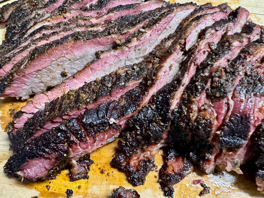 Slow-smoked beef brisket with a deep caramelized bark, seasoned with cherry hickory sweet BBQ rub, showing a rich smoke ring, tender sliced interior, and a glossy smoky-sweet finish from cherry and hickory wood smoke.
