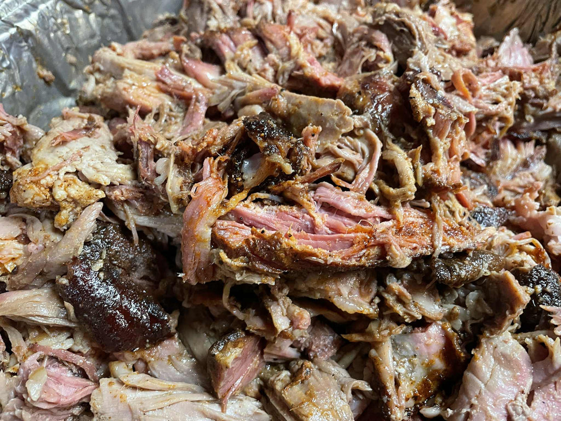 A BBQ pulled pork “101 guide” concept image featuring a smoked pork butt with bark crust and shredded pulled pork, alongside seasoning rubs and smoker tools, representing step-by-step instructions for preparing tender, juicy pulled pork.
