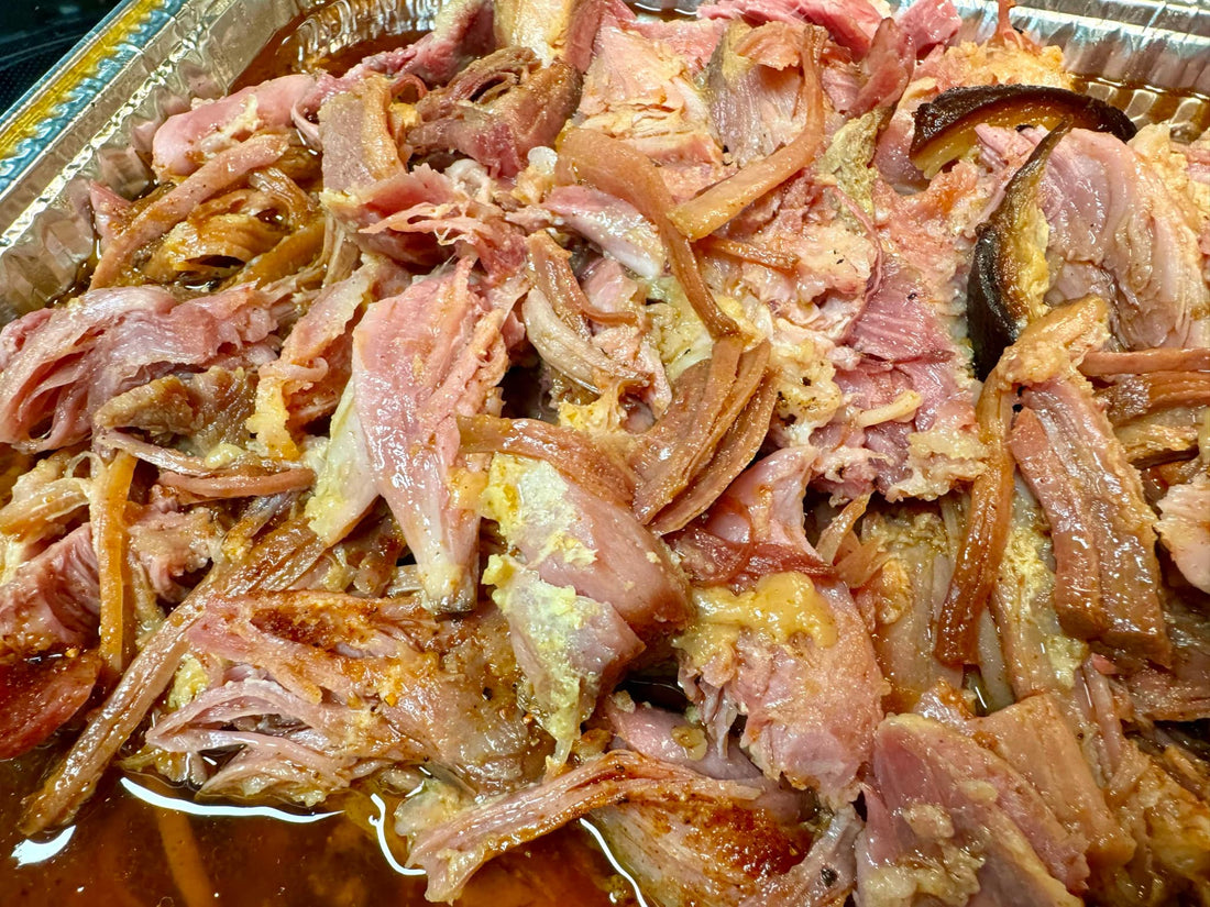 Smoked pulled ham seasoned with cherry hickory sweet BBQ rub, showing tender shredded ham with a caramelized, smoky glaze and juicy texture, presented as a sweet and smoky barbecue meat dish ideal for sliders or serving.