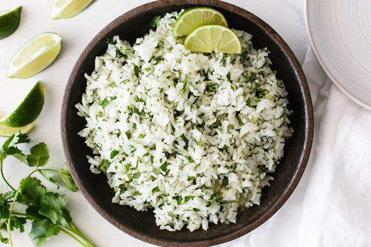 Chili lime cilantro rice made with fluffy white rice tossed in lime juice, cilantro, and chili lime seasoning, showing a vibrant, fresh, citrus-infused side dish with bold green herb accents and zesty flavor.