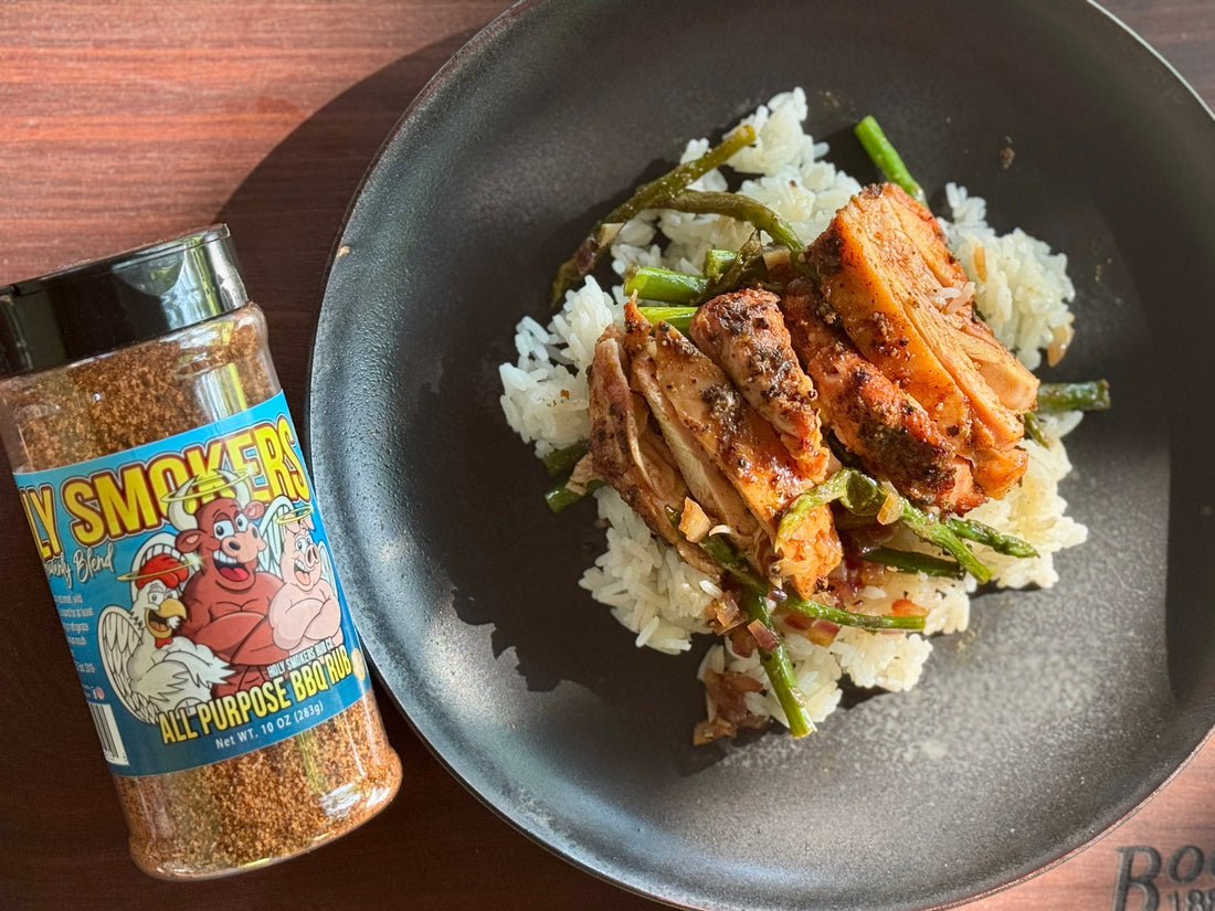 Smoked boneless skinless chicken thighs seasoned with Holy Smokers AP Rub, served over coconut aminos rice with steamed asparagus on a clean plated bowl, showcasing a healthy, smoky, and savory BBQ-style meal.