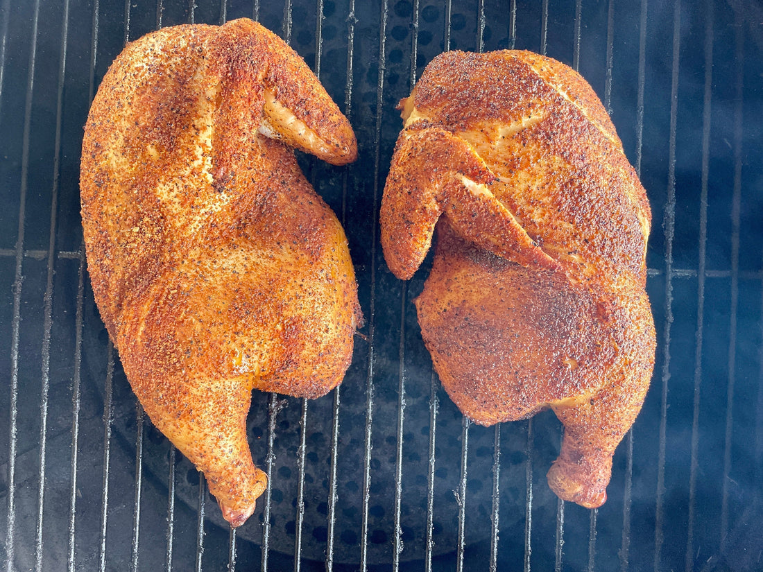 Smoked half chicken seasoned with Holy Smokers AP Rub, featuring crispy golden skin and juicy, tender meat, fresh off the smoker with a light wood-fired finish