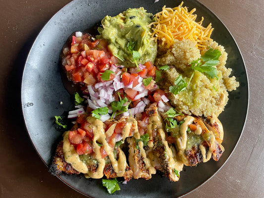 Jamaican jerk quinoa bowl featuring jerk-seasoned protein served over fluffy quinoa with fresh vegetables and a drizzle of chili lime sauce, showing a vibrant, healthy Caribbean-inspired bowl with bold sweet-heat flavor.