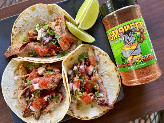 Smoked pork carnitas made from tender pork shoulder seasoned with chili lime rub, slow-smoked and braised in citrus juices, then crisped for a caramelized finish, showing juicy shredded pork with bold smoky, spicy, and citrus flavor.