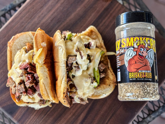 A loaded Philly cheesesteak sandwich filled with tender slow-smoked brisket, sautéed onions and peppers, and melted cheese, showing rich smoky bark and juicy beef packed into a toasted roll for a bold Texas-style BBQ sandwich.