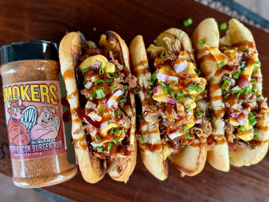 A loaded hot dog topped with rich smoked chili made from seasoned beef and pulled pork, drizzled with creamy nacho cheese and finished with a smoky seasoning blend, sitting on a bun for an indulgent “glizzy” style chili dog presentation.