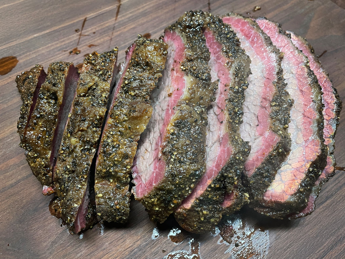 Hot and fast smoked brisket cooked over pecan wood, showing a barked exterior with a rich smoke ring and juicy sliced interior, seasoned with BBQ rubs for a tender, flavorful brisket prepared in a shortened cook time.