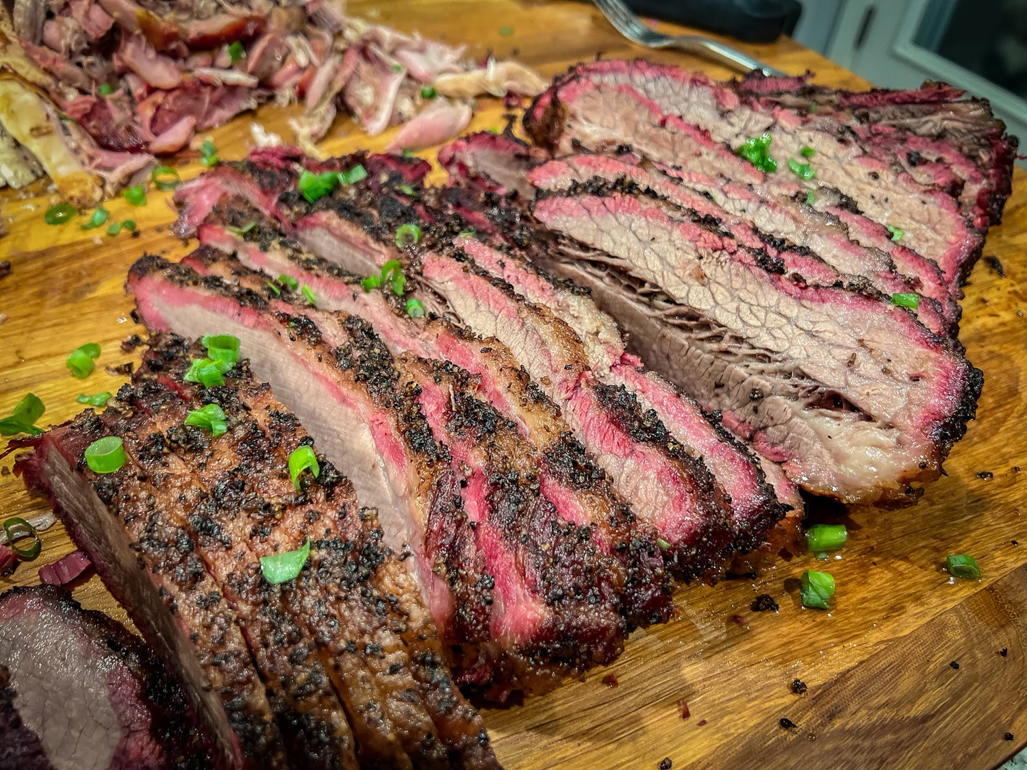 Texas-style smoked brisket coated with Holy Smokers BBQ seasoning, sliced on a wooden board with smoky flavor, bold bark texture, and mouthwatering barbecue presentation.