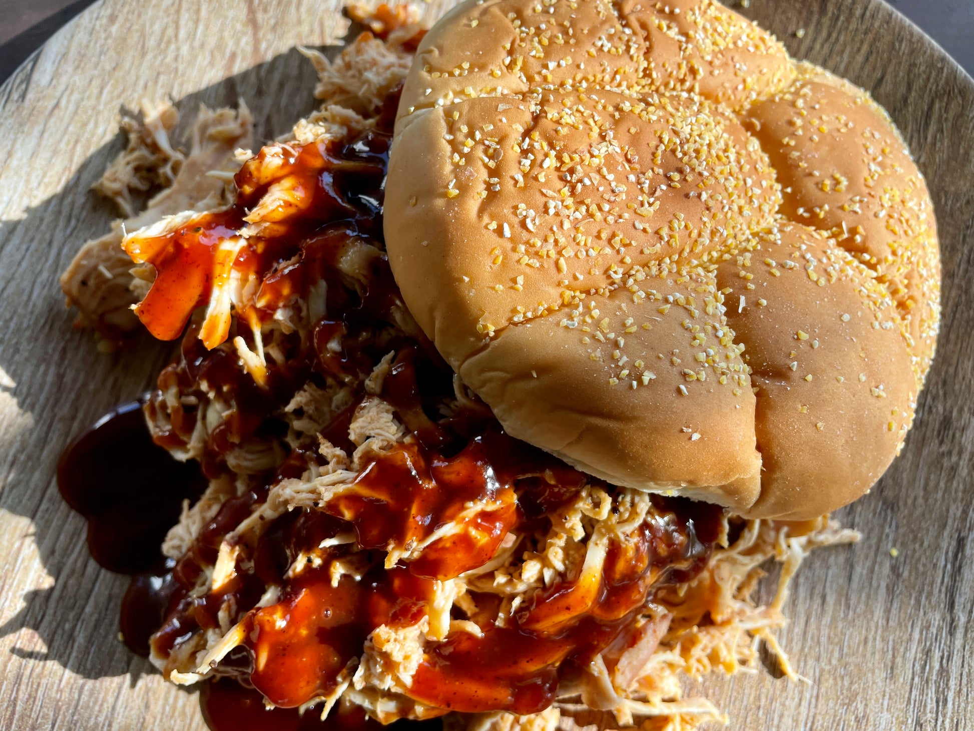 BBQ pulled pork sandwich flavored with Holy Smokers Smoked Apple Whisky seasoning and sweet smoky spices