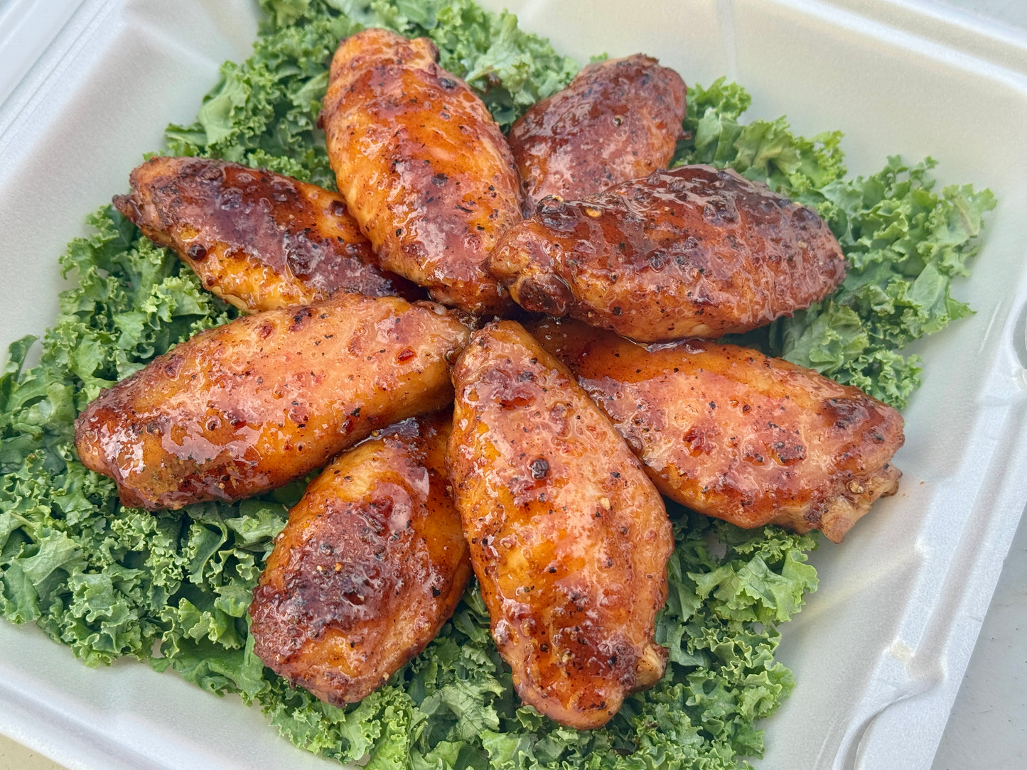 Chicken wings seasoned with Holy Smokers Rub Co. Smoked Apple Whiskey Rub, featuring a smoky apple, cinnamon, and whiskey-inspired flavor.