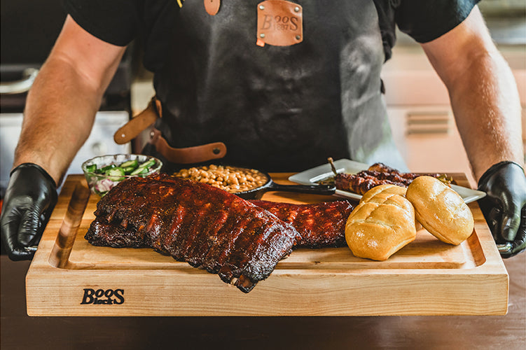 Holy Smokers BBQ feast bringing family together around smoked brisket, ribs, and grilled sides seasoned with award-winning BBQ rubs.